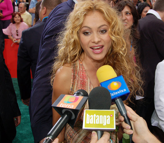 Paulina Rubio stops to chat with the media on the red carpet at the Latin Billboard Awards at the University of Miami in Coral Gables, Fla.