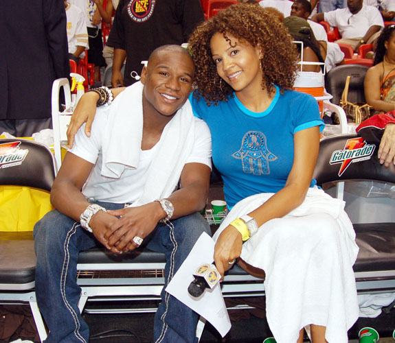 Boxing great Floyd Mayweather, Jr., left, with Tracy Wilson Mourning, at the Zo's Summer Groove All-Star basketball game in downtown Miami.