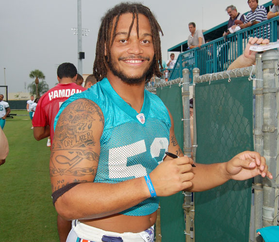 The always affable Channing Crowder engages fans during an autograph signing session at Miami Dolphins training camp in Davie, Fla.