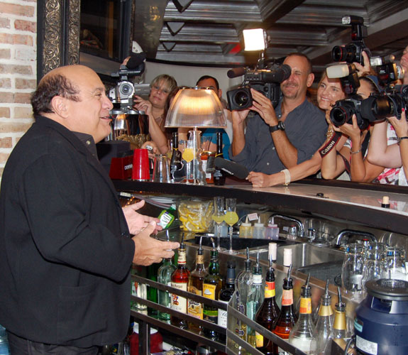 Veteran actor Danny DeVito plays bartender for members of the local media at his eponymous South Beach restaurant.