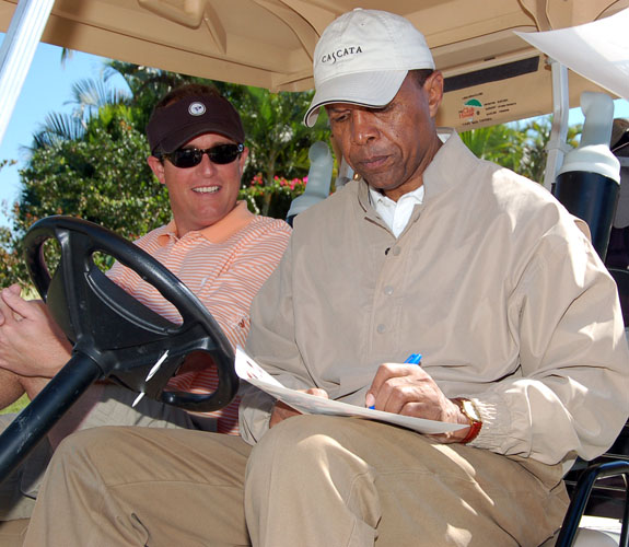 Ex-Chicago Bears running back Gale Sayers takes a break from the links to sign an autograph at Jim Brown's Super Bowl XLI Celebrity Golf Event.