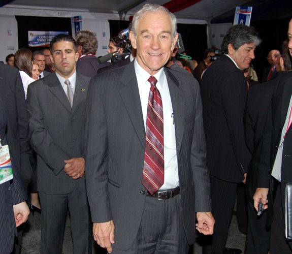 Texas conservative Ron Paul smiles for photographers at an impromptu media gathering after a GOP debate on campus at the University of Miami.