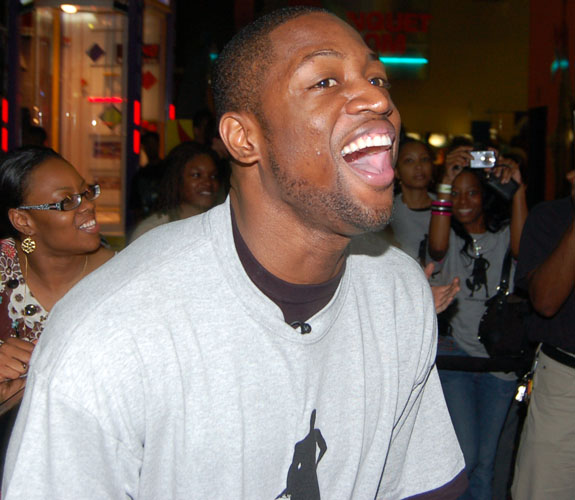 Miami Heat guard Dwyane Wade shares some yuks with guests at his Foundation's annual Christmas Party at Boomer's in Dania Beach, Fla.