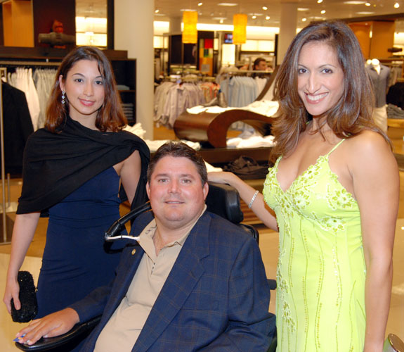 Marc Buoniconti is flanked by two friends at the grand opening party for Nordstrom at the Aventura Mall.